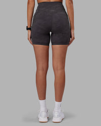 Woman wearing Elixir Ultra High-Rise 6" Short Pockets - Dark Storm Wash | Model:Rhiley | Size:S