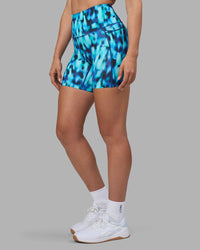 Woman wearing Elixir Ultra High-Rise 6" Short Pockets - Luminous | Model:Sophie | Size:S
