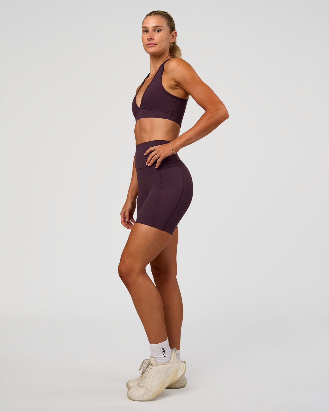 Woman wearing Elixir Ultra High-Rise 6” Short Pockets - Midnight Plum | Model:Emelia | Size:S