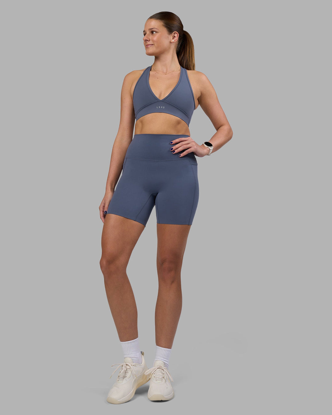 Woman wearing Elixir Ultra High-Rise 6&quot; Short Pockets - Night Shadow | Model:Phoebe | Size:S