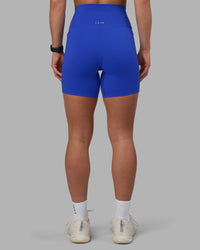 Woman wearing Elixir Ultra High-Rise 6" Short Pockets - Power Cobalt | Model:Keisha | Size:S
