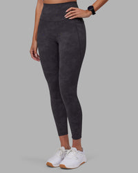 Woman wearing Elixir Ultra High-Rise 7/8 Legging Pockets - Dark Storm Wash | Model:Rhiley | Size:S