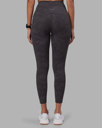 Woman wearing Elixir Ultra High-Rise 7/8 Legging Pockets - Dark Storm Wash | Model:Rhiley | Size:S