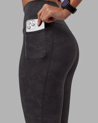 Woman wearing Elixir Ultra High-Rise 7/8 Legging Pockets - Dark Storm Wash | Model:Rhiley | Size:S