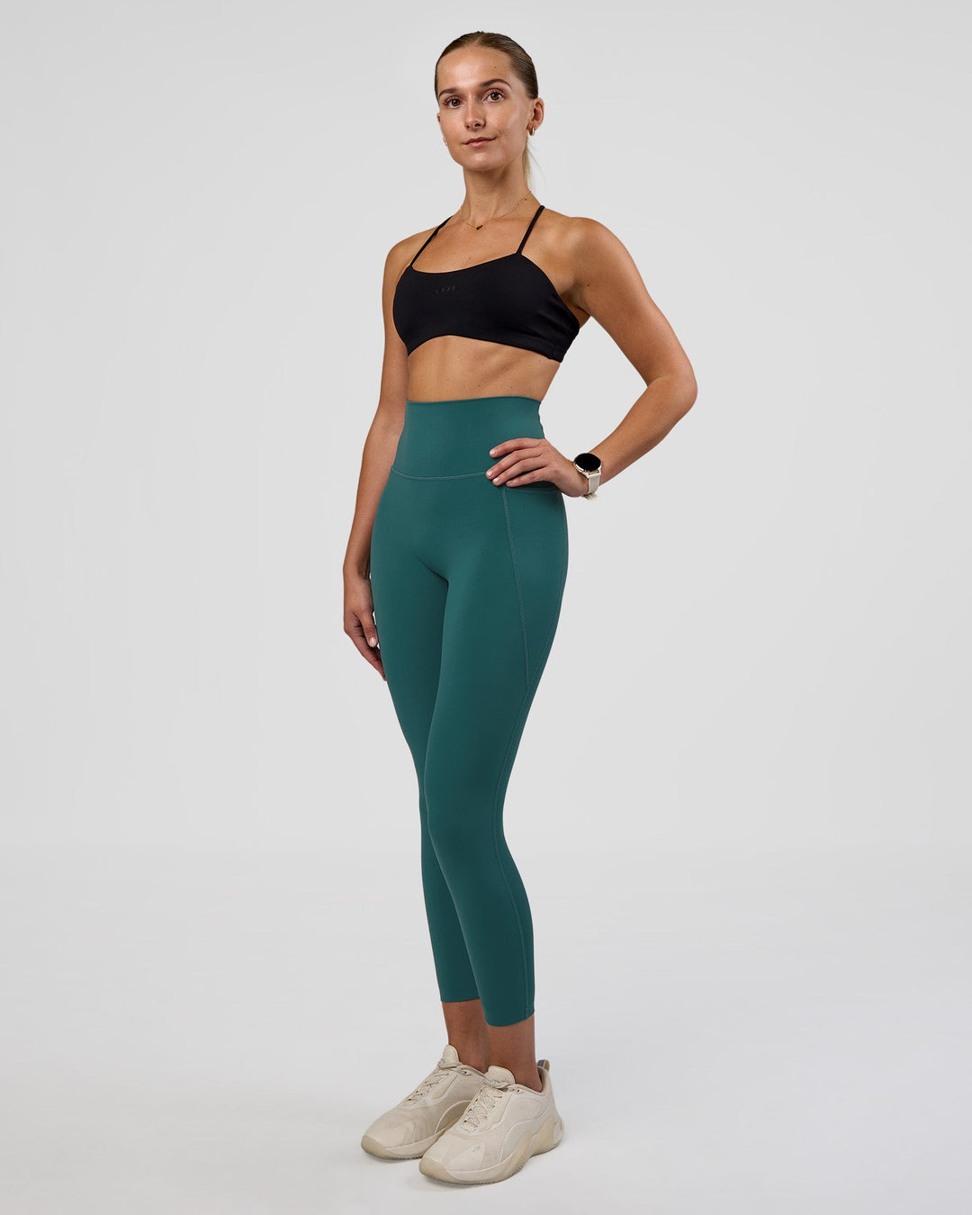 Woman wearing Elixir Ultra High-Rise 7/8 Legging Pockets - Transformative Teal | Model:Myrte | Size:S - view 5