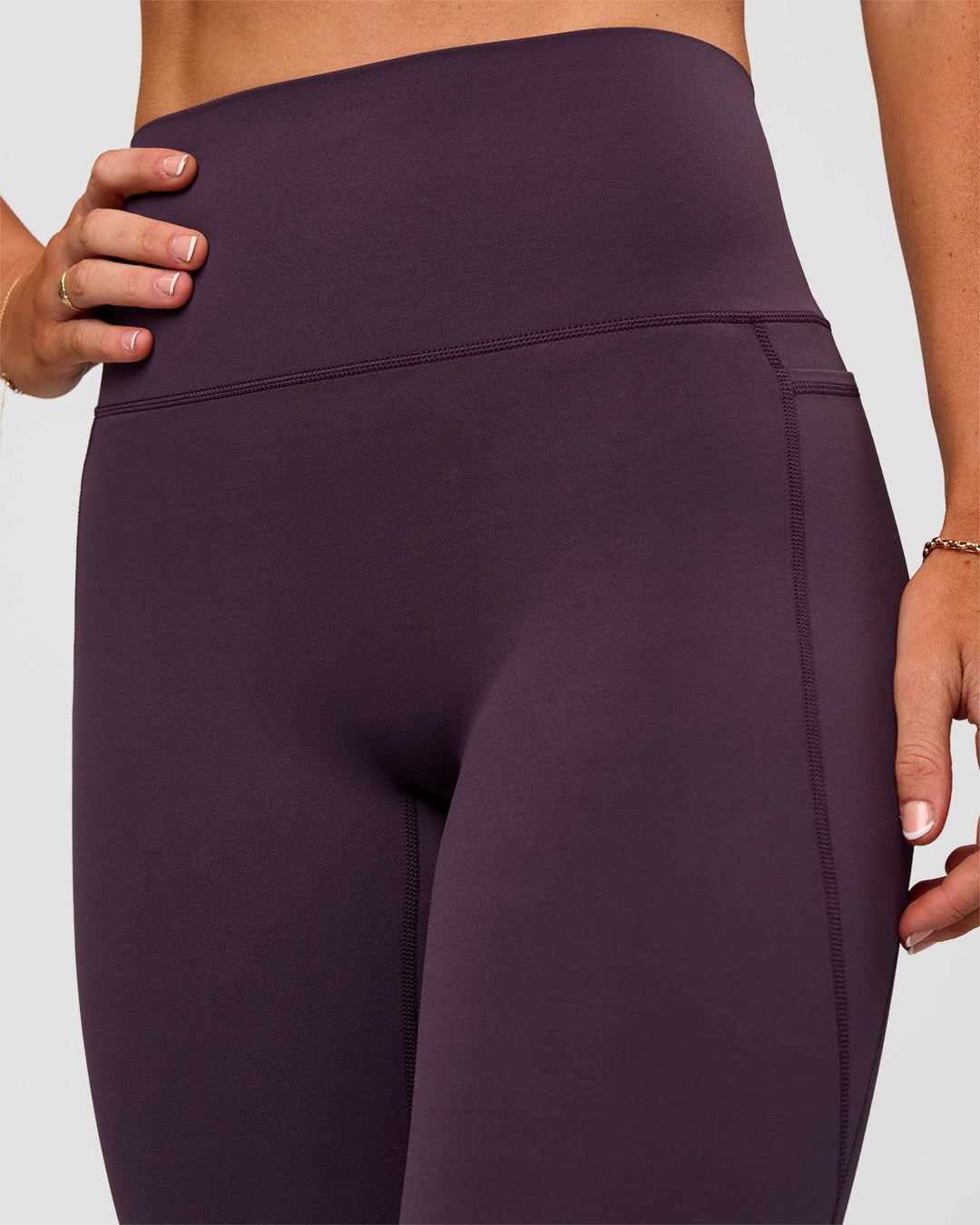 Woman wearing Elixir Ultra High-Rise Full Length Legging Pockets - Midnight Plum | Model:Emelia | Size:S