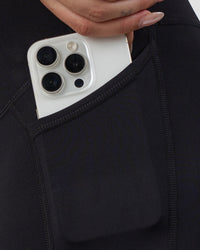 Woman wearing Elixir Ultra High-Rise Maternity 6" Short Pockets - Black | Model:Kitahna | Size:S