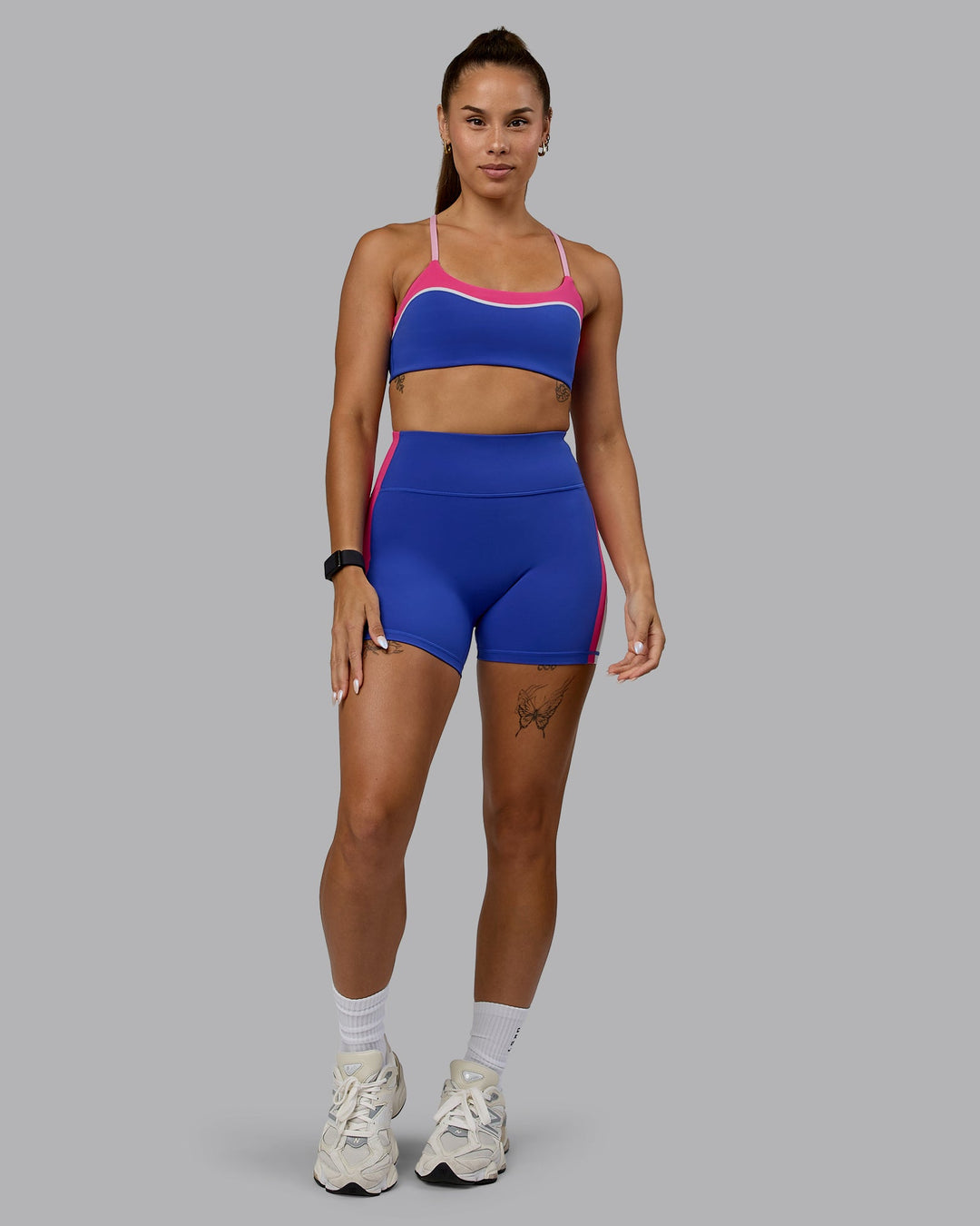 Woman wearing Embrace Sports Bra - Power Cobalt-Fuchsia Pink