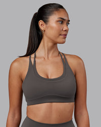 Woman wearing Empower Sports Bra - Dark Storm | Model:Rhiley | Size:S