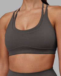 Woman wearing Empower Sports Bra - Dark Storm | Model:Rhiley | Size:S