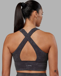 Woman wearing Evoke Longline Sports Bra - Dark Storm Wash | Model:Rhiley | Size:S