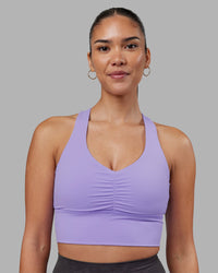 Woman wearing Evoke Longline Sports Bra - Violet Ray | Model:Rhiley | Size:S