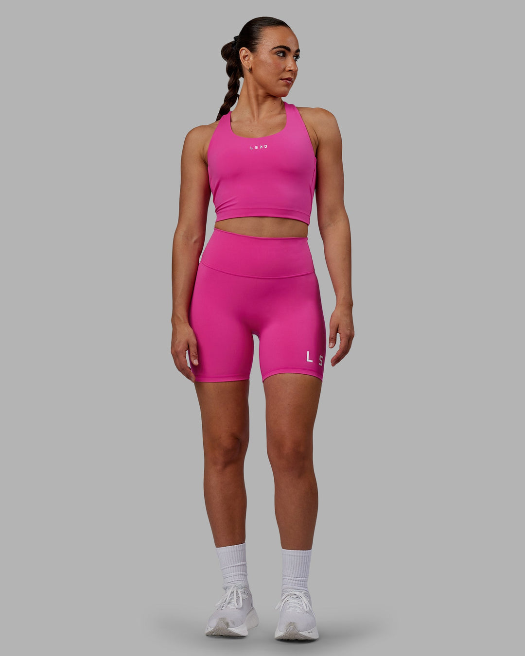 Woman wearing Evolved Mid Short Tights - Fuchsia Pink-White