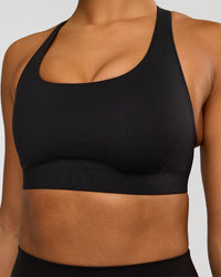 Woman wearing Flow Bonded Scoop Neck Sports Bra - Black | Model:Rosie | Size:S
