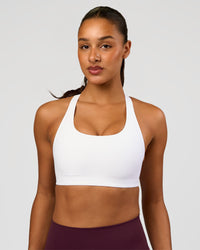 Woman wearing Flow Bonded Scoop Neck Sports Bra - White | Model:Rosie | Size:S