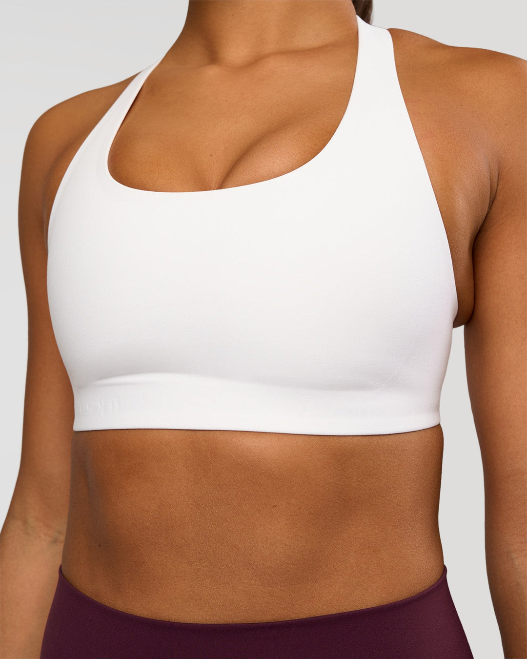 Woman wearing Flow Bonded Scoop Neck Sports Bra - White | Model:Rosie | Size:S