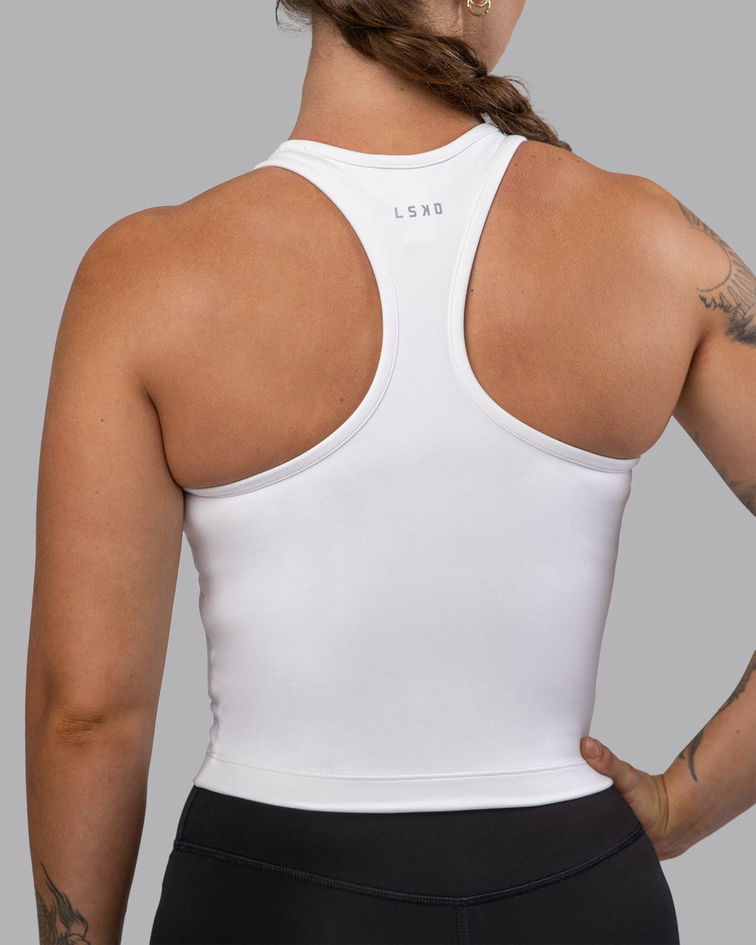 Woman wearing Flow Performance Tank - White | Model:Robyn | Size:S