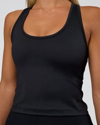 Woman wearing Flow Scoop Neck Performance Tank - Black | Model:Amity | Size:S | Thumbnail Index: 0