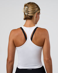 Woman wearing Flow Scoop Neck Performance Tank - White | Model:Amity | Size:S