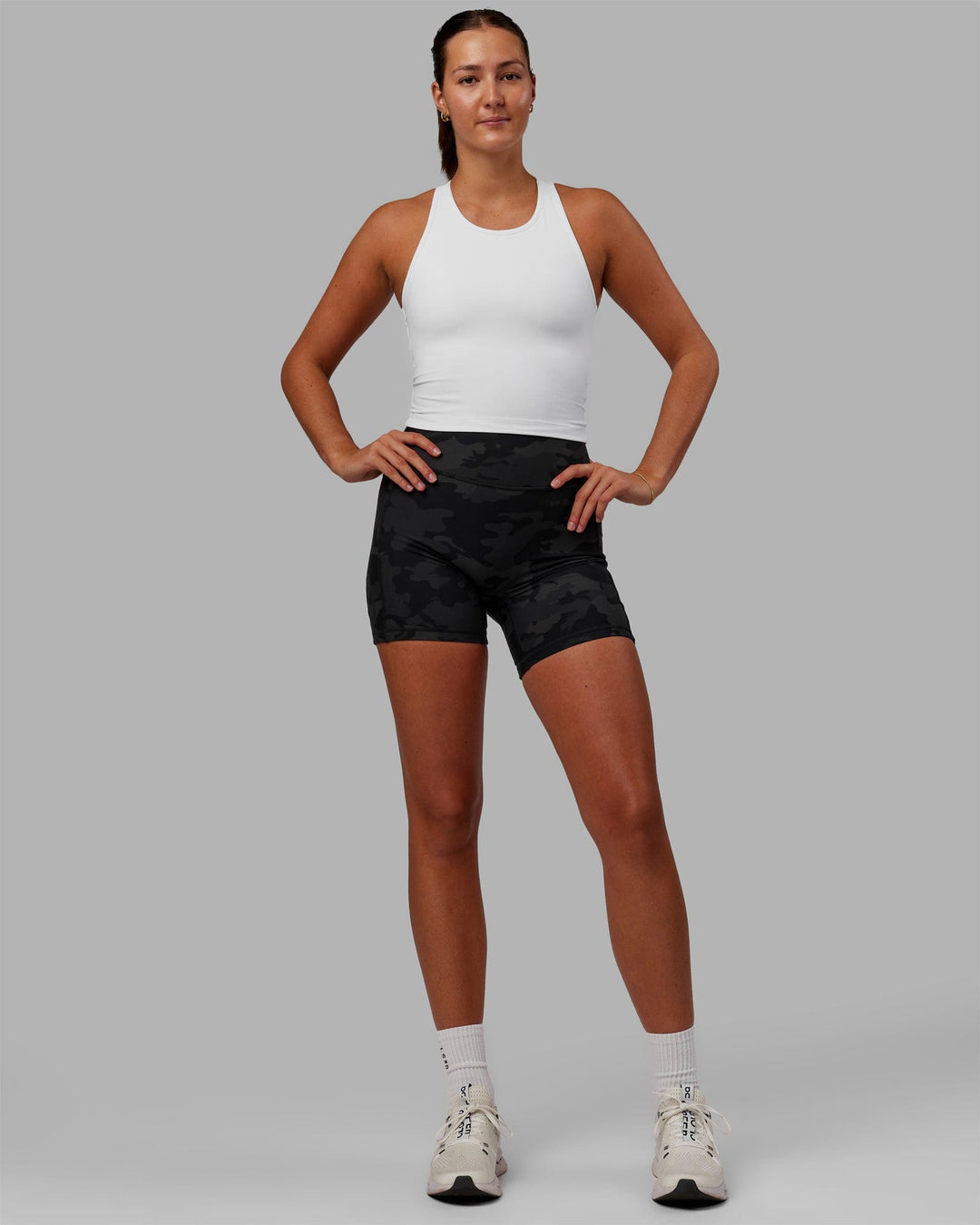 Woman wearing Flow Shelf Bra Performance Tank - White