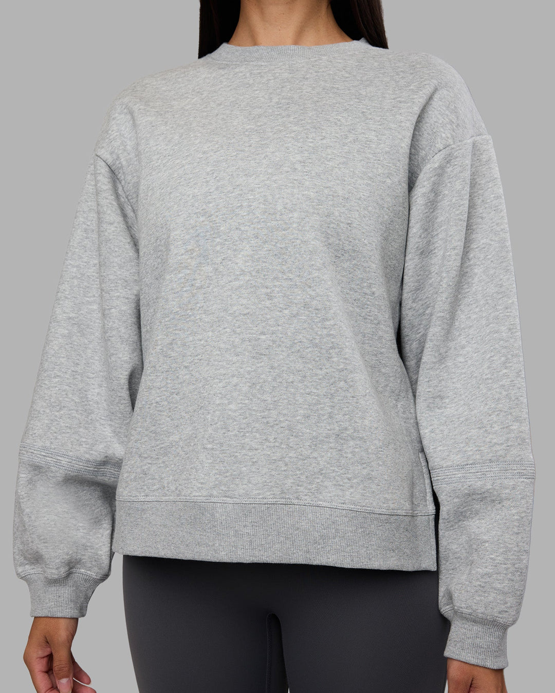 Woman wearing Full Form Fleece Sweater with Side Slits - Marl Grey | Model:Rhiley | Size:S