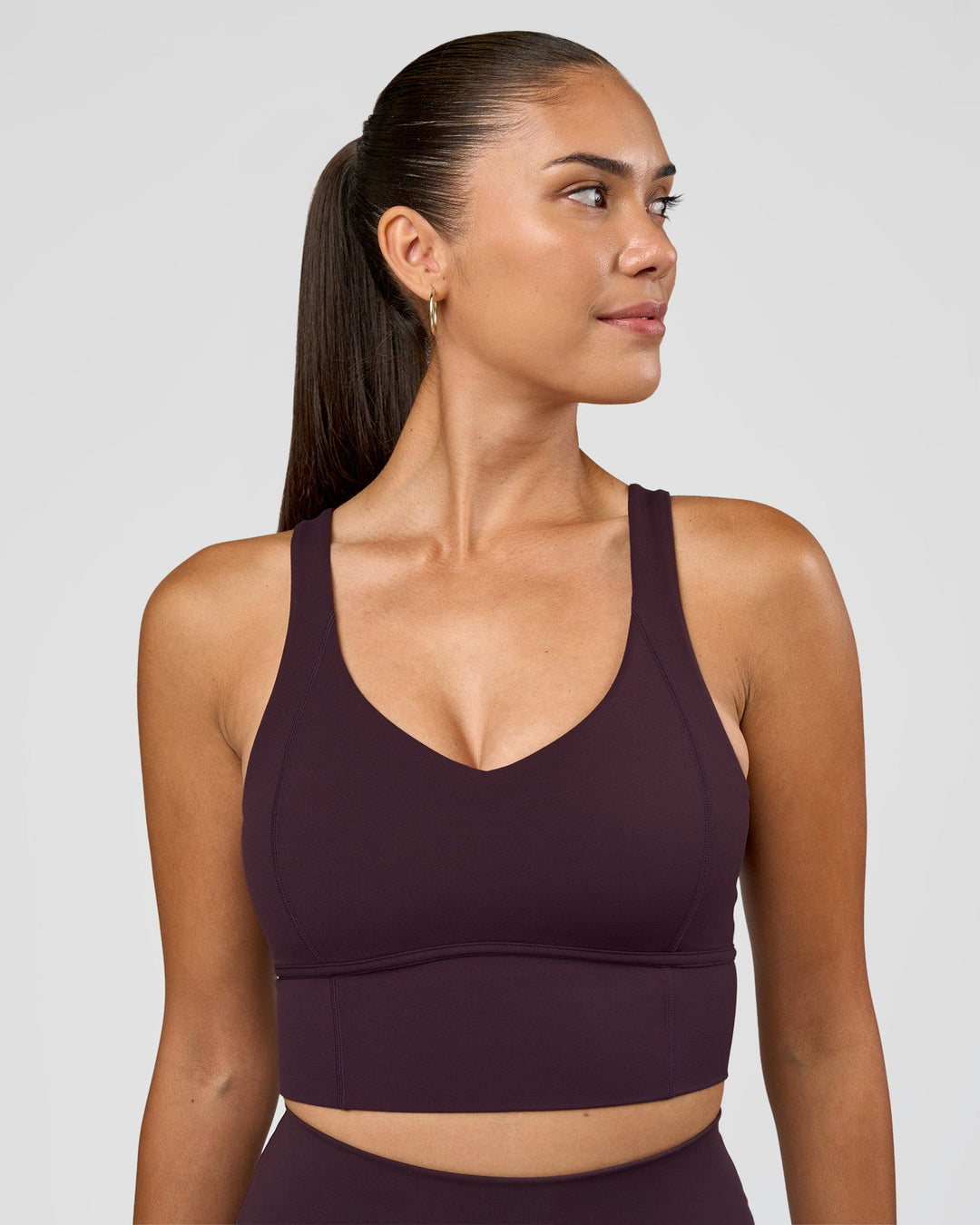 Woman wearing Function Longline Sports Bra - Midnight Plum | Model:Rhiley | Size:S