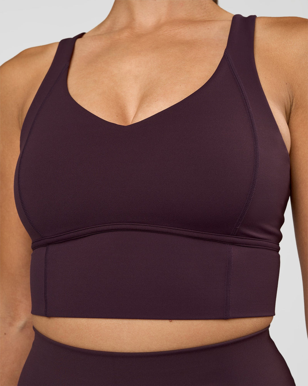 Woman wearing Function Longline Sports Bra - Midnight Plum | Model:Rhiley | Size:S