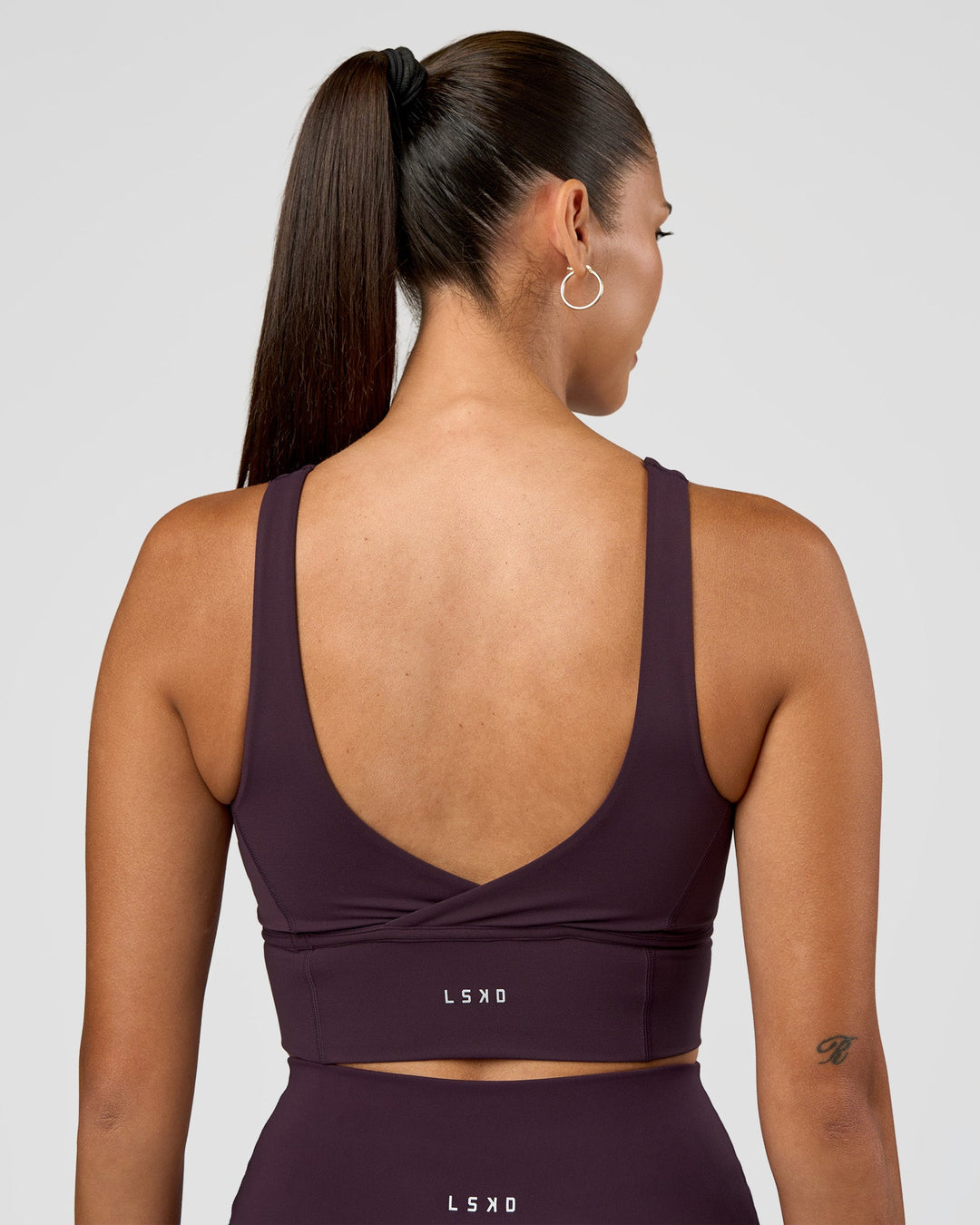 Woman wearing Function Longline Sports Bra - Midnight Plum | Model:Rhiley | Size:S