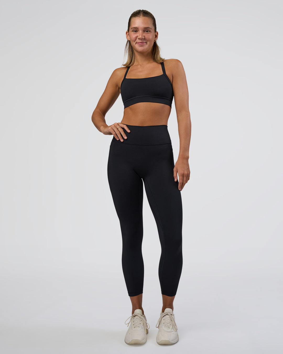 Woman wearing Fusion Ultra High-Rise 7/8 Legging Pockets - Black | Model:Amity | Size:S