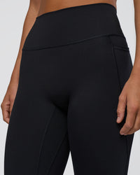 Woman wearing Fusion Ultra High-Rise 7/8 Legging Pockets - Black | Model:Amity | Size:S
