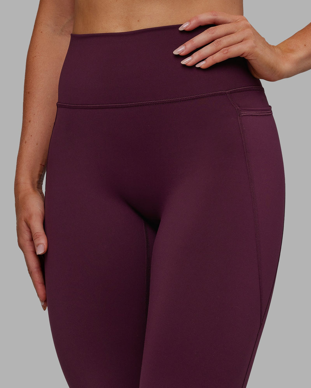 Woman wearing Fusion Ultra High-Rise 7/8 Legging Pockets - Cherry Lacquer | Model:Paris | Size:S - view 6