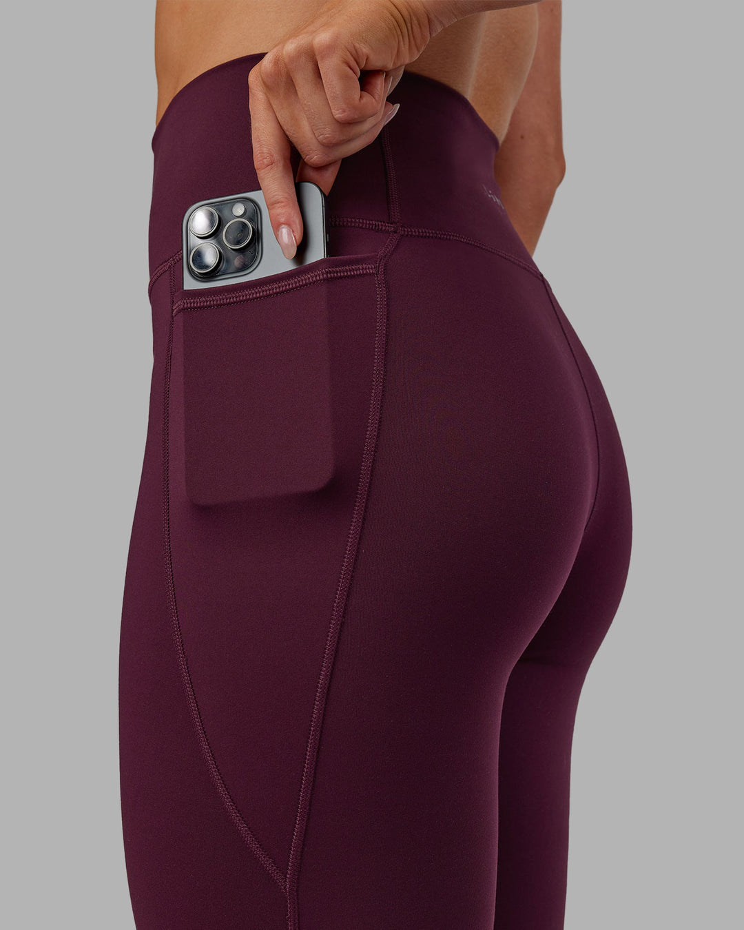 Woman wearing Fusion Ultra High-Rise 7/8 Legging Pockets - Cherry Lacquer | Model:Paris | Size:S - view 4