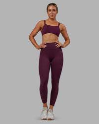 Woman wearing Fusion Ultra High-Rise 7/8 Legging Pockets - Cherry Lacquer | Model:Paris | Size:S
