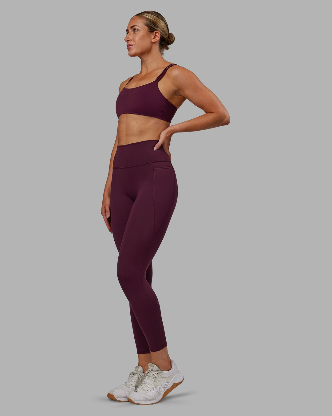 Woman wearing Fusion Ultra High-Rise 7/8 Legging Pockets - Cherry Lacquer | Model:Paris | Size:S - view 7