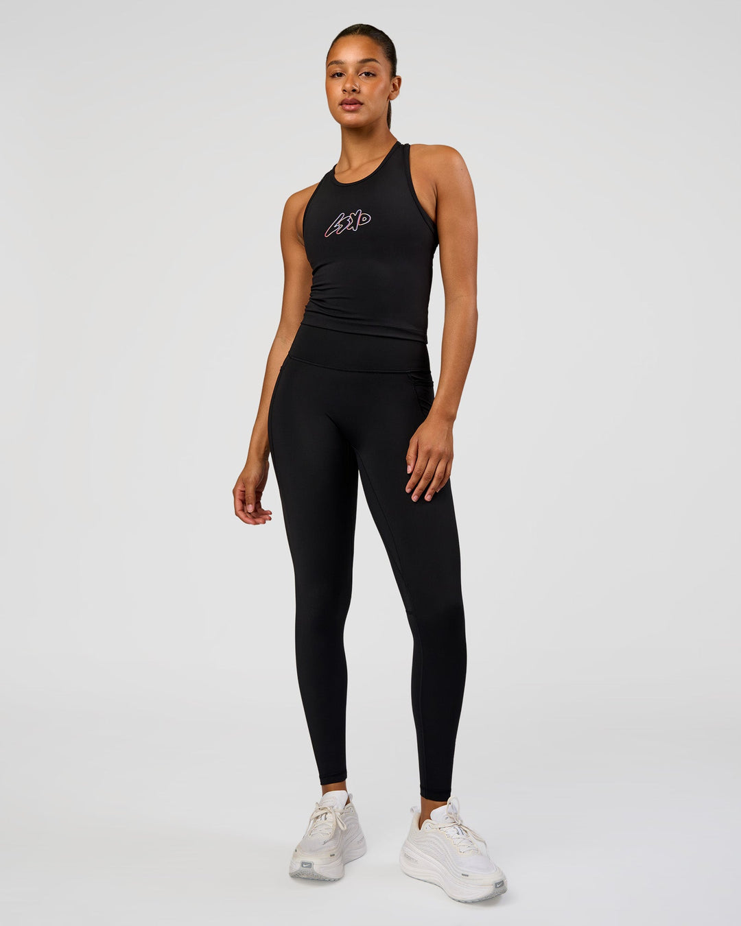 Woman wearing Fusion Graphic Ultra High-Rise Full Length Legging Pockets - Black-Radiate | Model:Rosie | Size:S