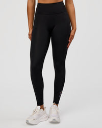 Woman wearing Fusion Graphic Ultra High-Rise Full Length Legging Pockets - Black-Radiate | Model:Rosie | Size:S
