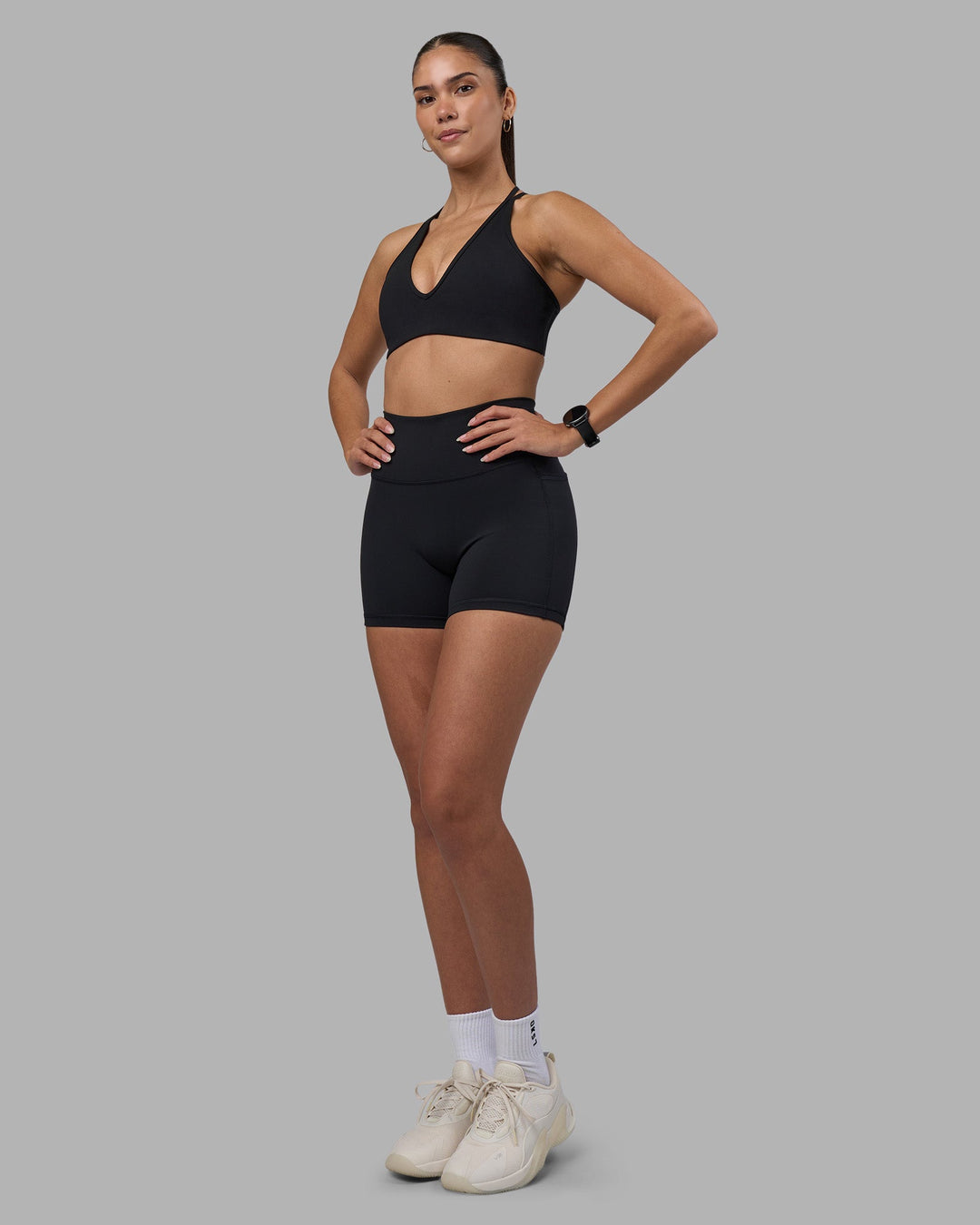 Woman wearing Fusion High-Rise 4&quot; Short Pockets - Black | Model:Rhiley | Size:S