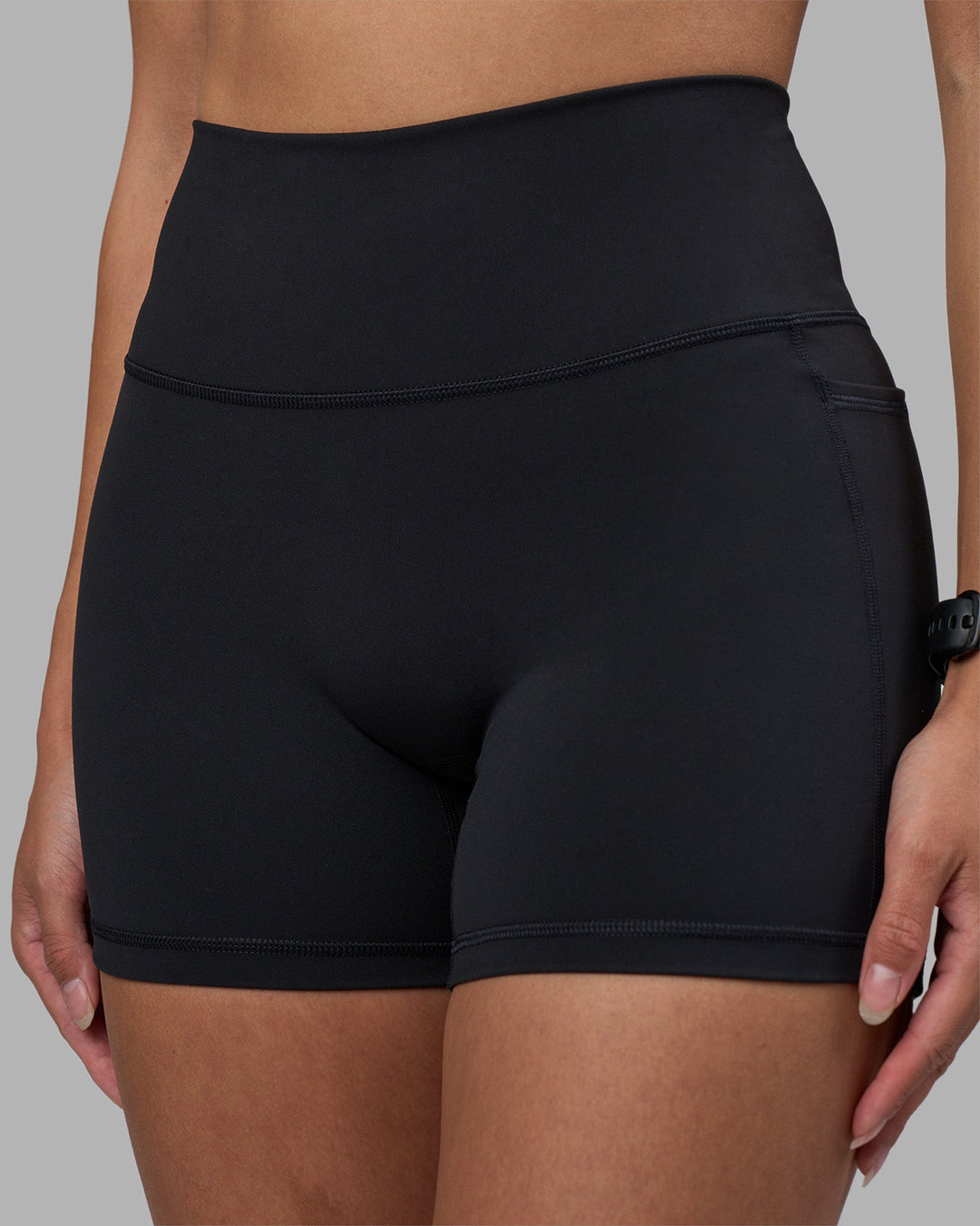 Woman wearing Fusion High-Rise 4&quot; Short Pockets - Black | Model:Rhiley | Size:S