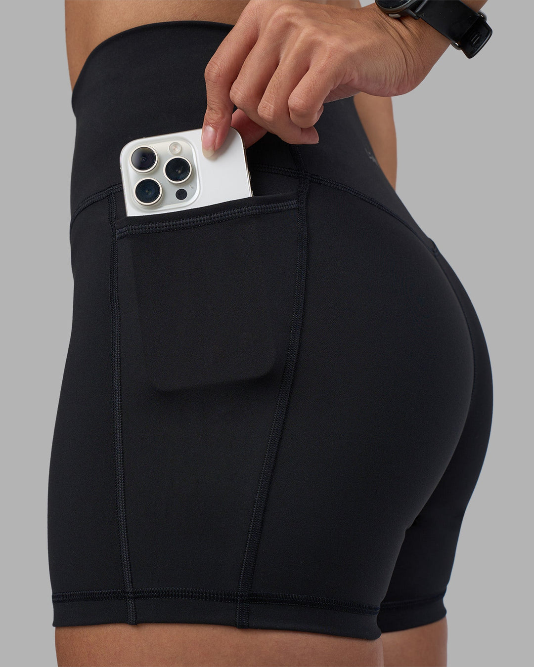 Woman wearing Fusion High-Rise 4&quot; Short Pockets - Black | Model:Rhiley | Size:S