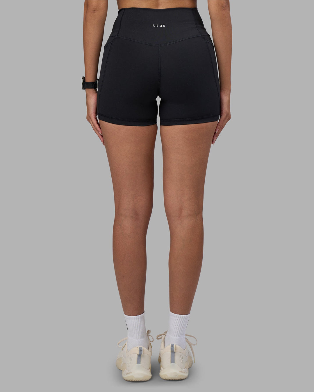 Woman wearing Fusion High-Rise 4&quot; Short Pockets - Black | Model:Rhiley | Size:S