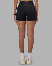 Woman wearing Fusion High-Rise 4" Short Pockets - Black | Model:Rhiley | Size:S