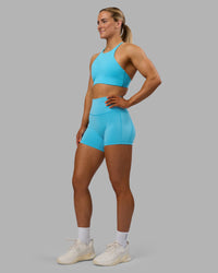 Woman wearing Fusion High-Rise 4" Short Pockets - Blue Atoll | ModelGeorgia | Size:S