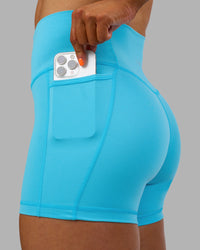 Woman wearing Fusion High-Rise 4" Short Pockets - Blue Atoll | ModelGeorgia | Size:S
