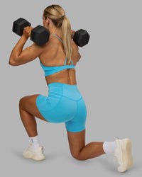Woman wearing Fusion High-Rise 4" Short Pockets - Blue Atoll | ModelGeorgia | Size:S