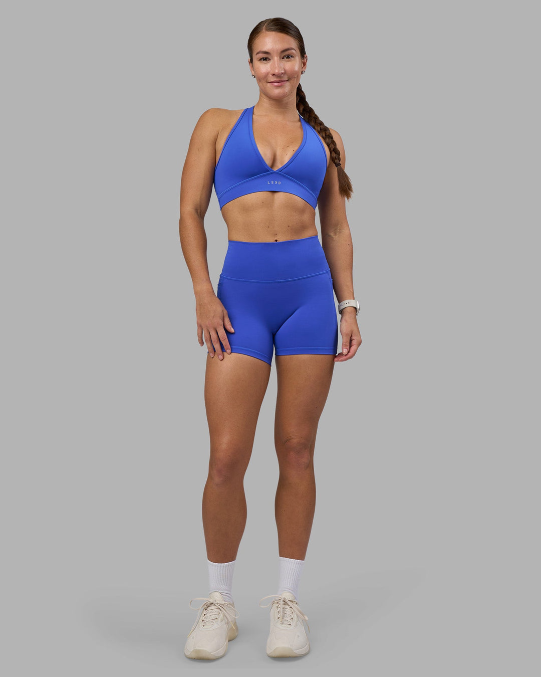 Woman wearing Fusion High-Rise 4" Short Pockets - Power Cobalt | Model:Hannah | Size:S