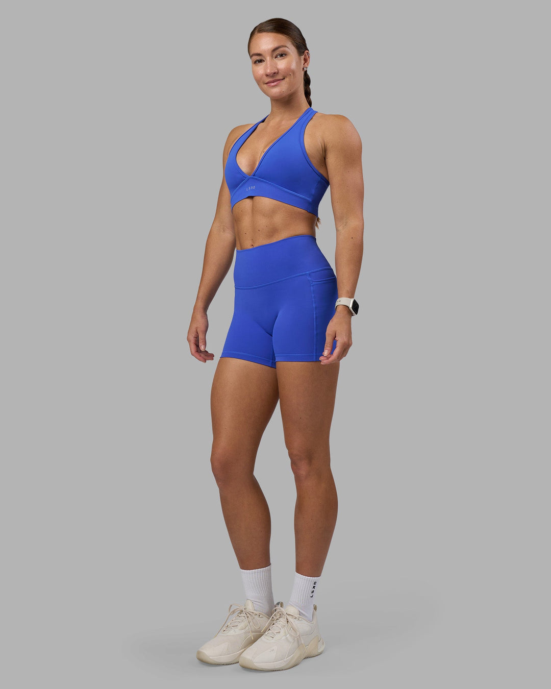 Woman wearing Fusion High-Rise 4" Short Pockets - Power Cobalt | Model:Hannah | Size:S