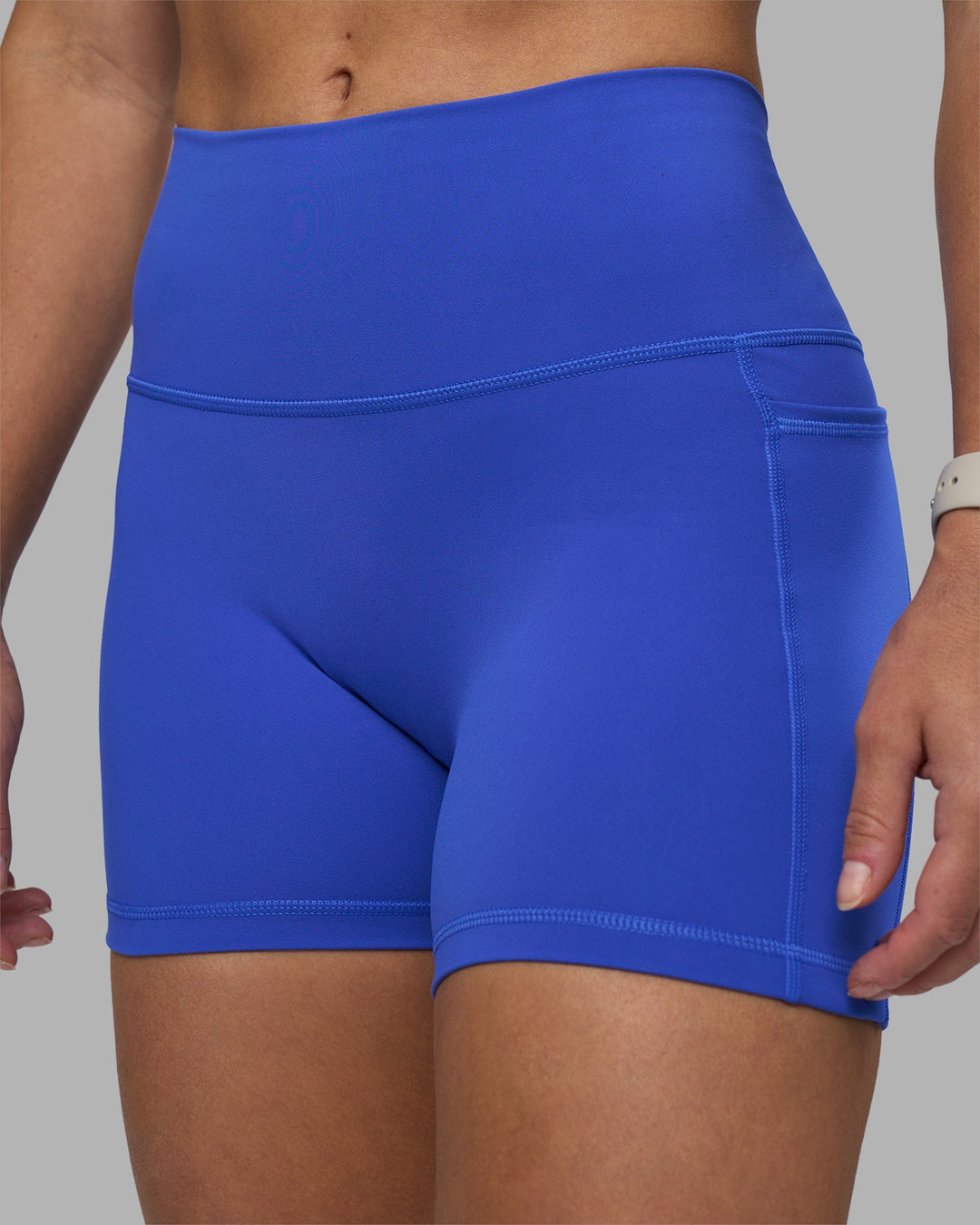 Woman wearing Fusion High-Rise 4" Short Pockets - Power Cobalt | Model:Hannah | Size:S