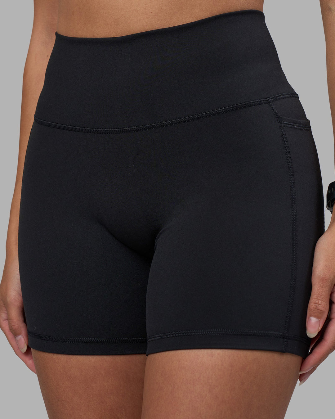 Woman wearing Fusion High-Rise 6&quot; Short Pockets - Black | Model:Rhiley | Size:S