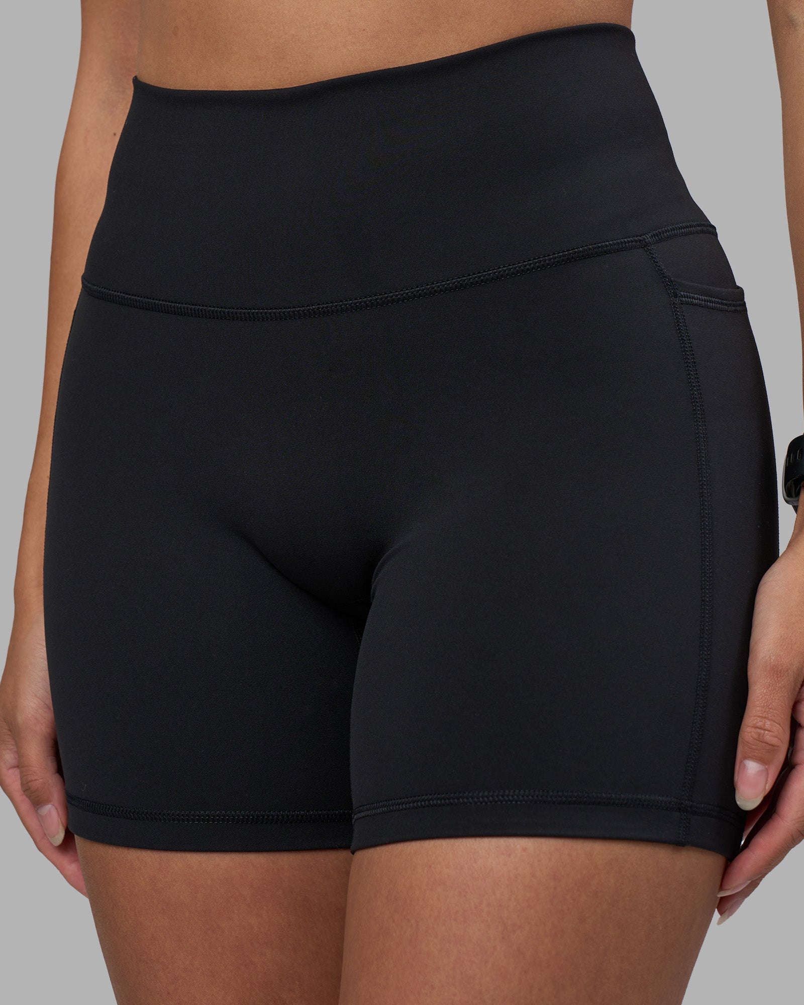 Woman wearing Fusion High-Rise 6" Short Pockets - Black | Model:Rhiley | Size:S