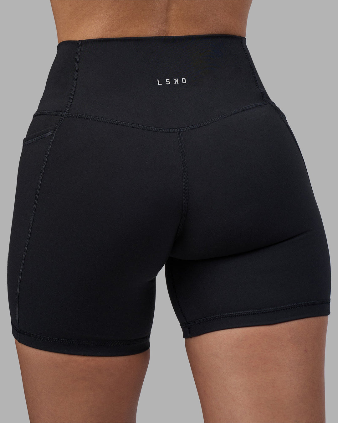 Woman wearing Fusion High-Rise 6&quot; Short Pockets - Black | Model:Rhiley | Size:S